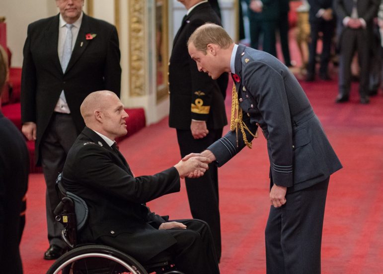 Prince William presenting PC Prdley with his MBE. s